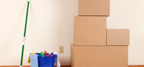 Cleaning and moving supplies. Cardboard boxes and a mop in an empty room.Please also see: